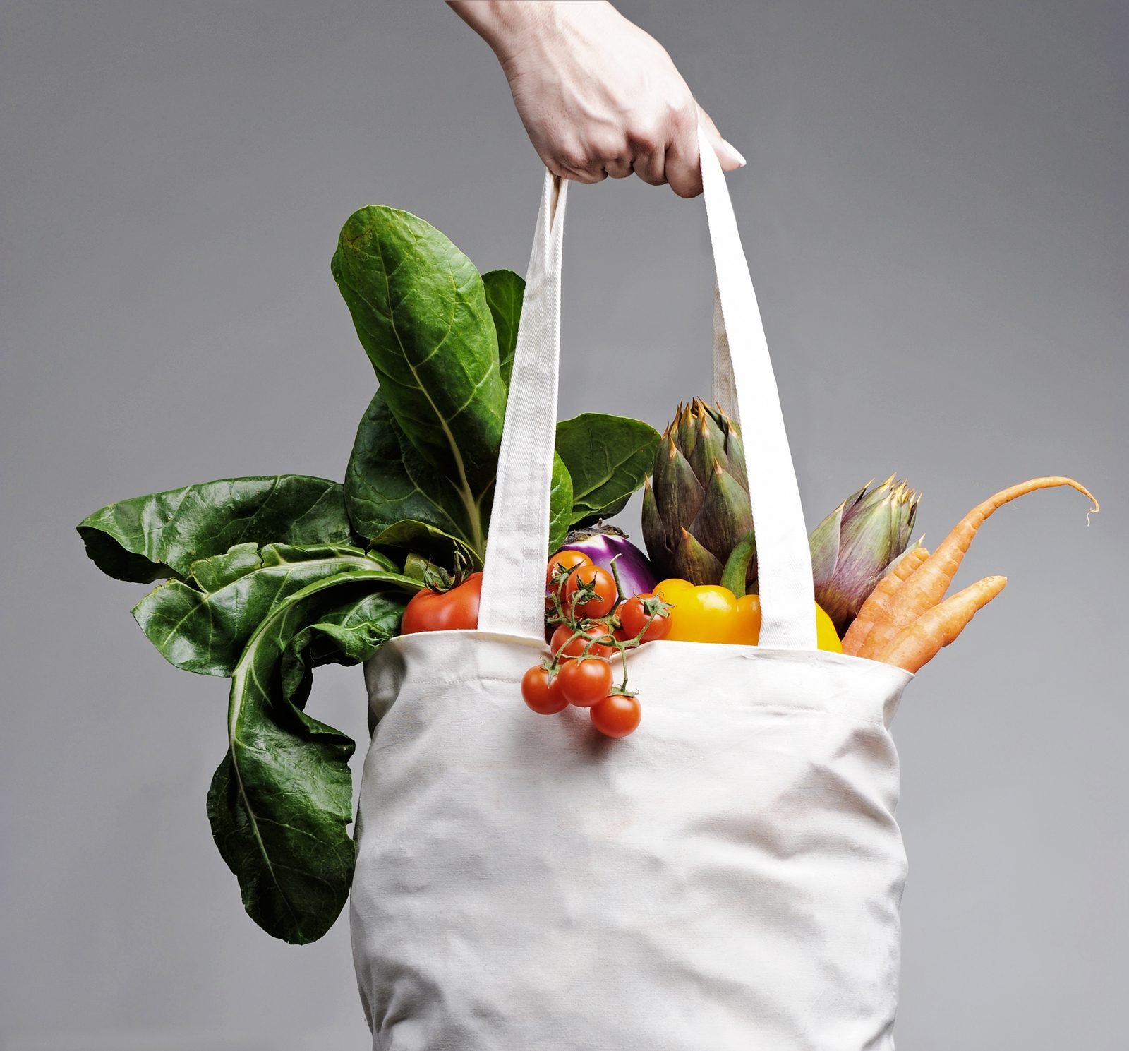 Tote bag full of leafy greens and vegetables